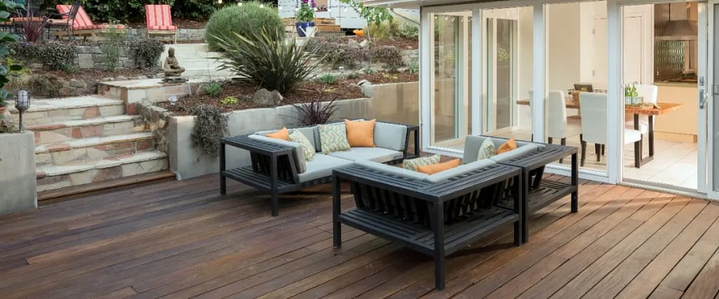 A patio featuring cedar decking and furniture, creating a cozy outdoor living space.